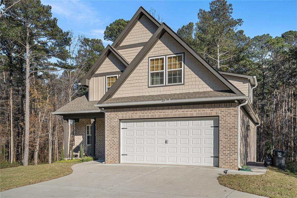 85 Jane Harris Road Dallas, GA 30157 - Photo 3 of 33 a front view of a house with a yard and garage