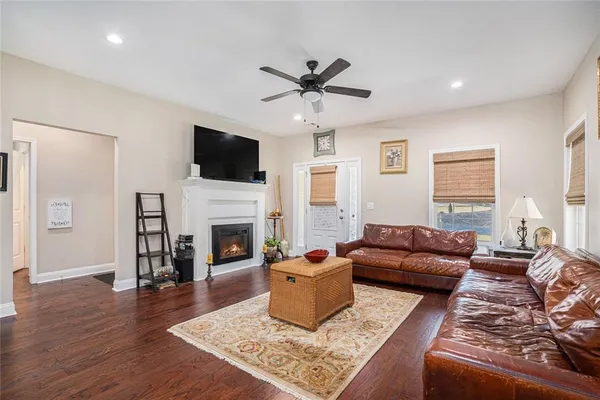 a living room with furniture a flat screen tv and a fireplace