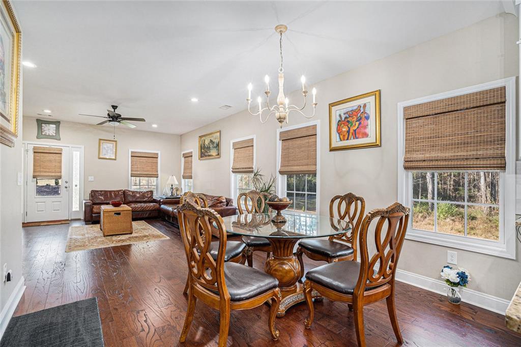 85 Jane Harris Road Dallas, GA 30157 - Photo 8 of 33 a dining room with furniture a chandelier and wooden floor