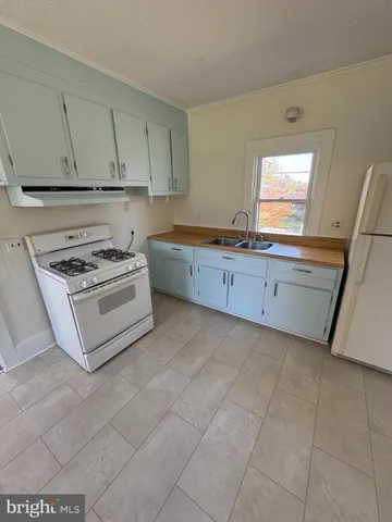 a kitchen with cabinets and appliances