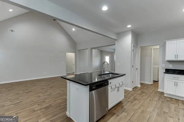 a kitchen with granite countertop a refrigerator and a stove