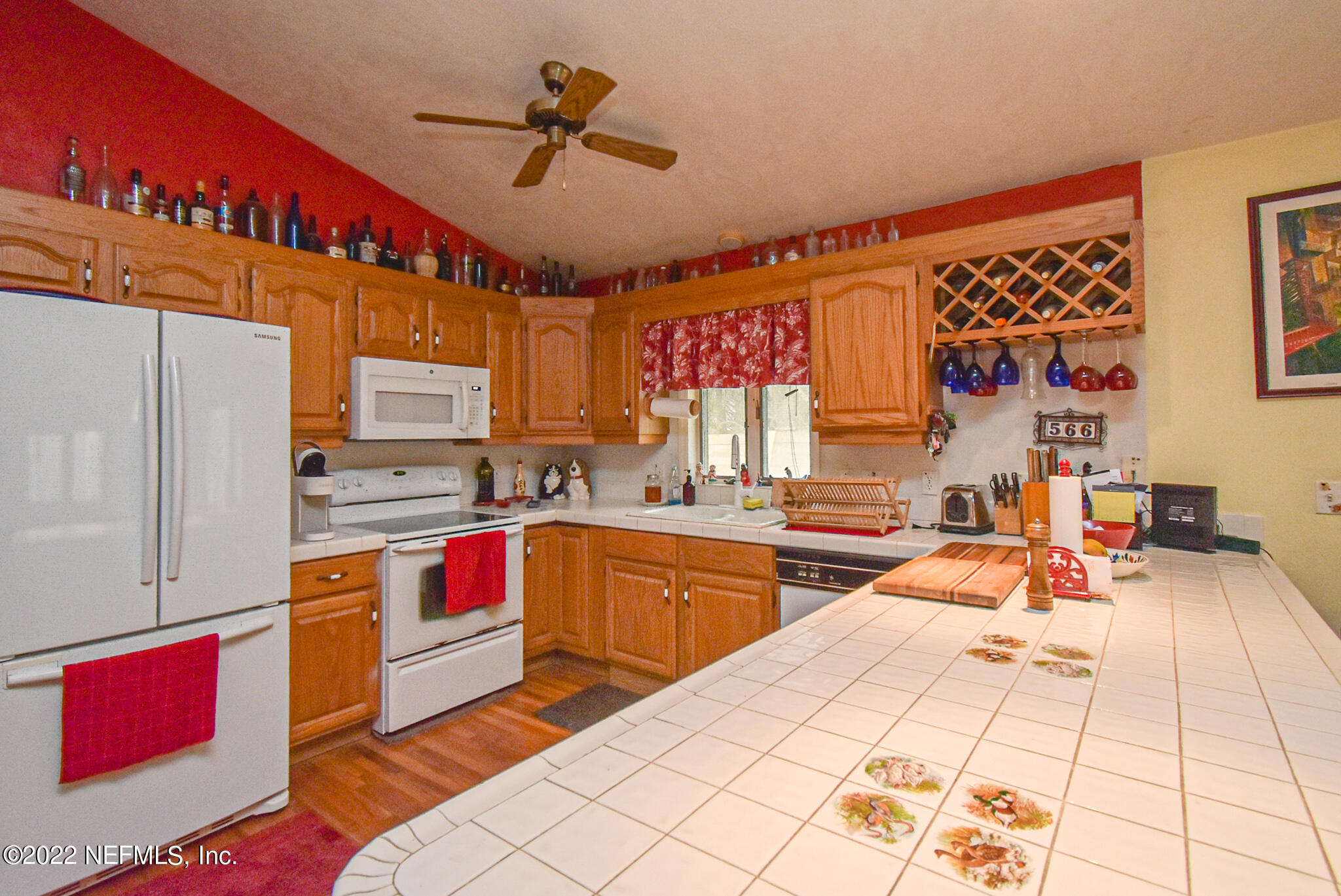 566 Clifton Road Crescent City, FL 32112 - Photo 24 of 41 a kitchen with stainless steel appliances kitchen island granite countertop a sink and cabinets