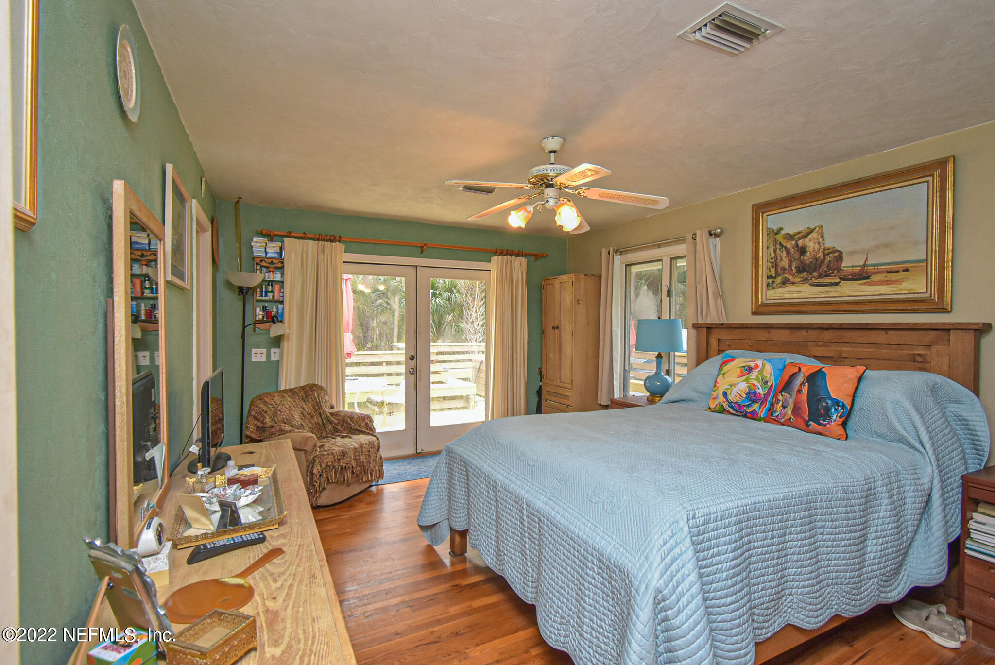 566 Clifton Road Crescent City, FL 32112 - Photo 25 of 41 a bedroom with a large bed and a chandelier