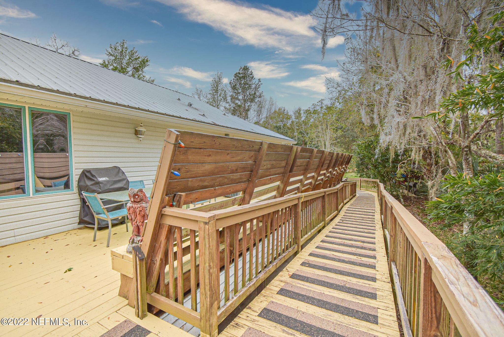 566 Clifton Road Crescent City, FL 32112 - Photo 6 of 41 a view of balcony with wooden floor and seating space