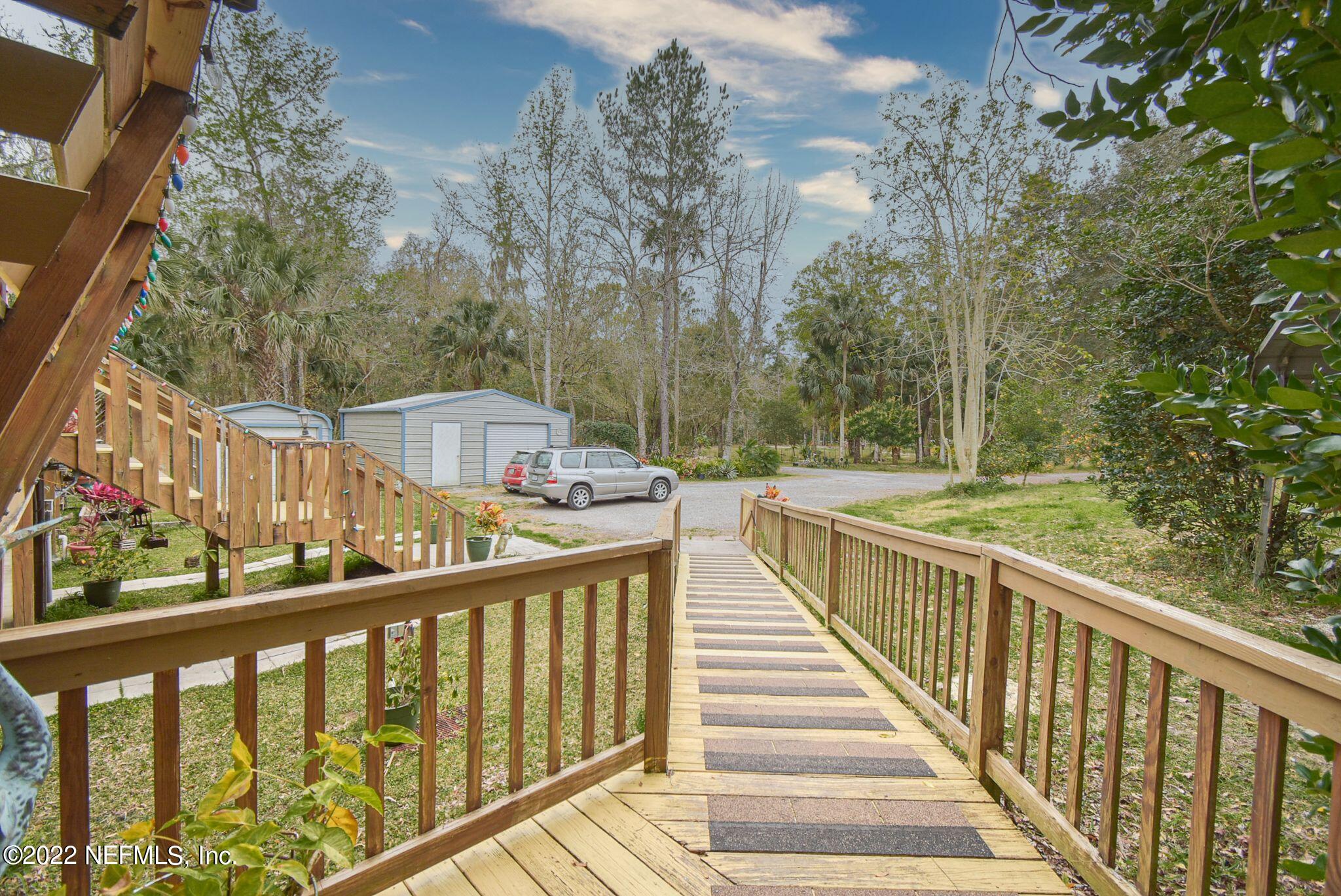 566 Clifton Road Crescent City, FL 32112 - Photo 7 of 41 a view of a balcony with wooden fence
