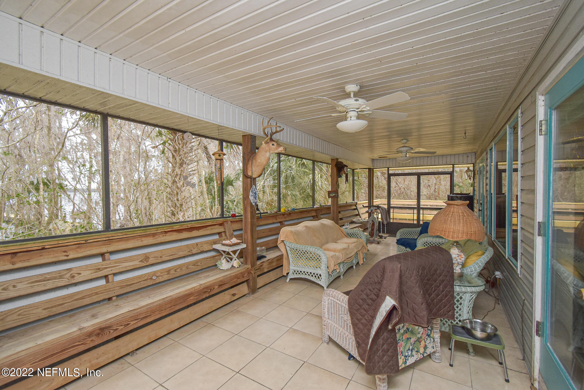 566 Clifton Road Crescent City, FL 32112 - Photo 10 of 41 a living room with furniture ceiling fan and a large window