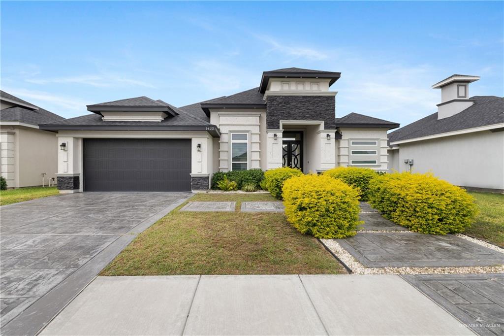 a front view of a house with garden