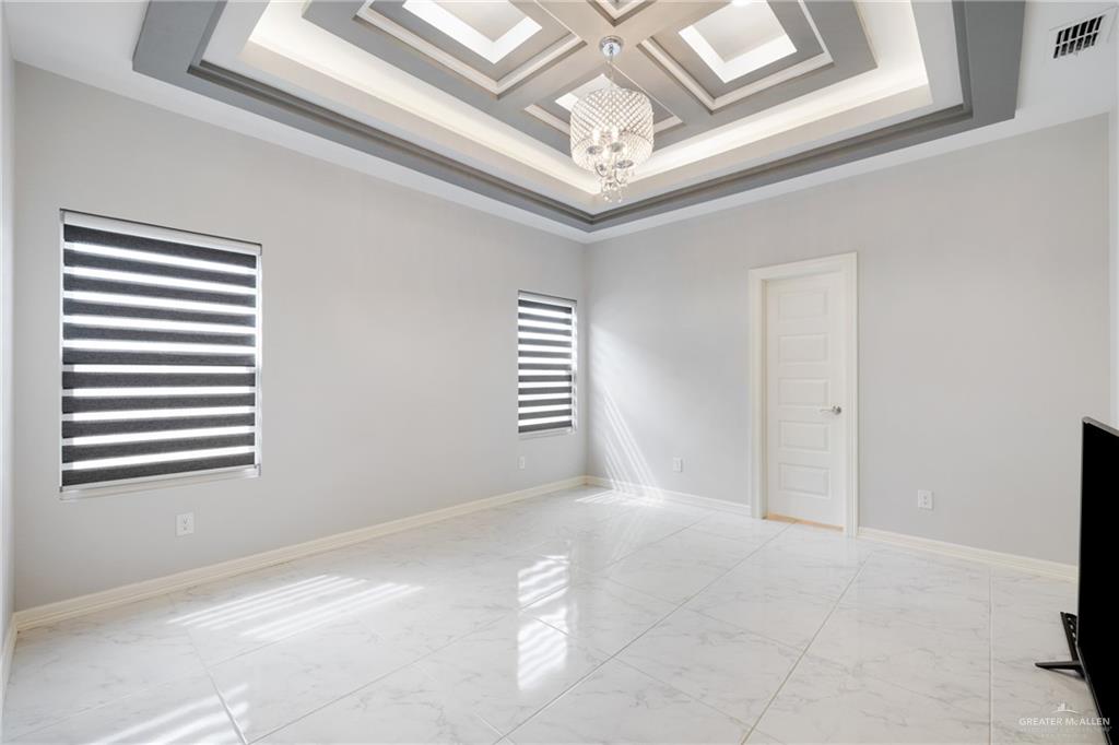 1422 South Esperanza Street Pharr, TX 78577 - Photo 8 of 16 a view of a hallway with windows and chandelier