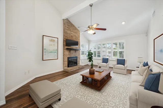 a living room with furniture ceiling fan and a rug