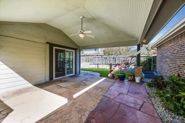 a view of a chairs and table in backyard of the house