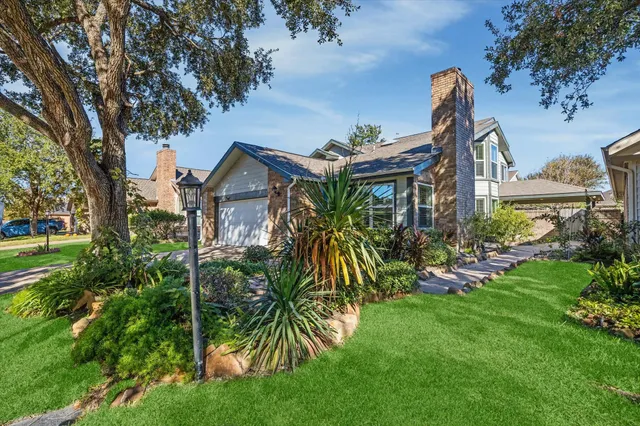 a view of a house with a yard and plants