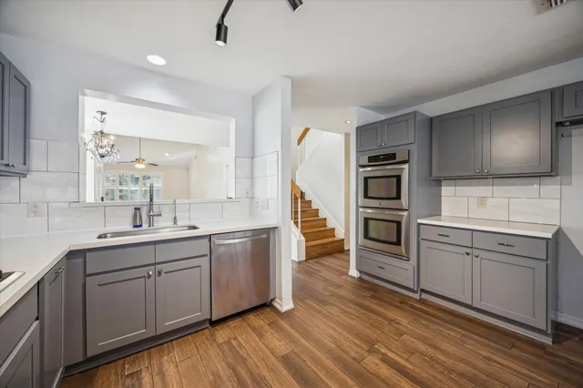 a kitchen with a sink cabinets and stainless steel appliances