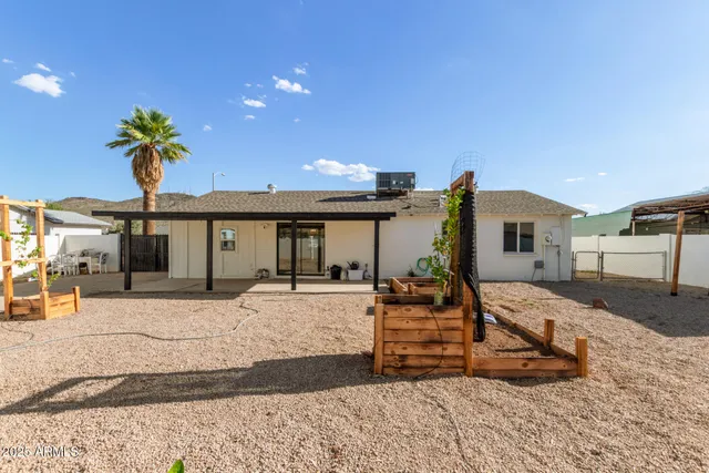 a front view of a house with a yard outdoor seating and garage