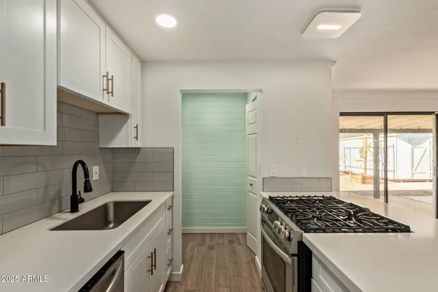 a kitchen that has a sink and a stove
