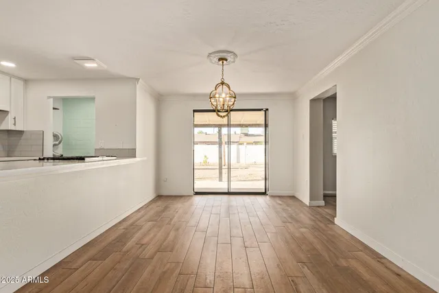 a view of a kitchen with wooden floor and a sink