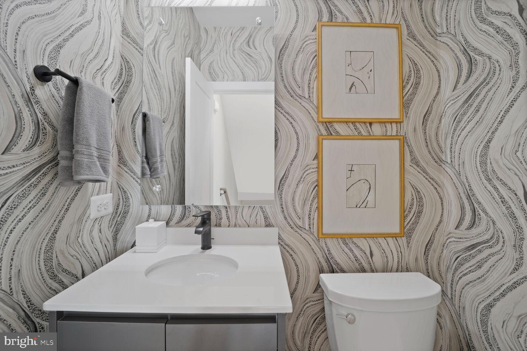 61 Lower Service Road Northwest, Unit HOMESITE 908 Washington, DC 20422 - Photo 17 of 22 a bathroom with a toilet sink and mirror