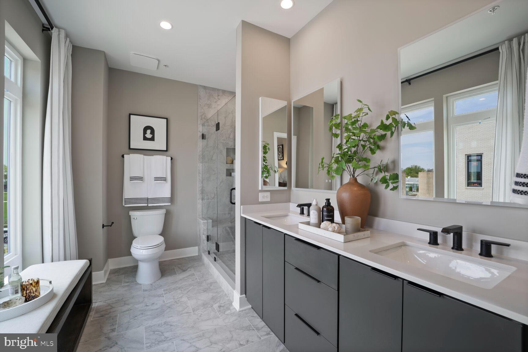 61 Lower Service Road Northwest, Unit HOMESITE 908 Washington, DC 20422 - Photo 18 of 22 a en suite bathroom with a granite countertop sink and a mirror