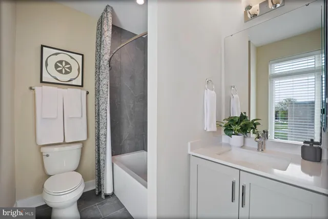 a bathroom with a shower a toilet and a sink