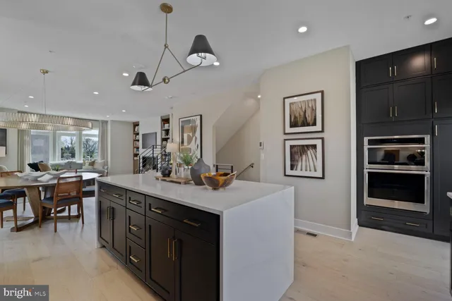 a kitchen with kitchen island a stove and a refrigerator