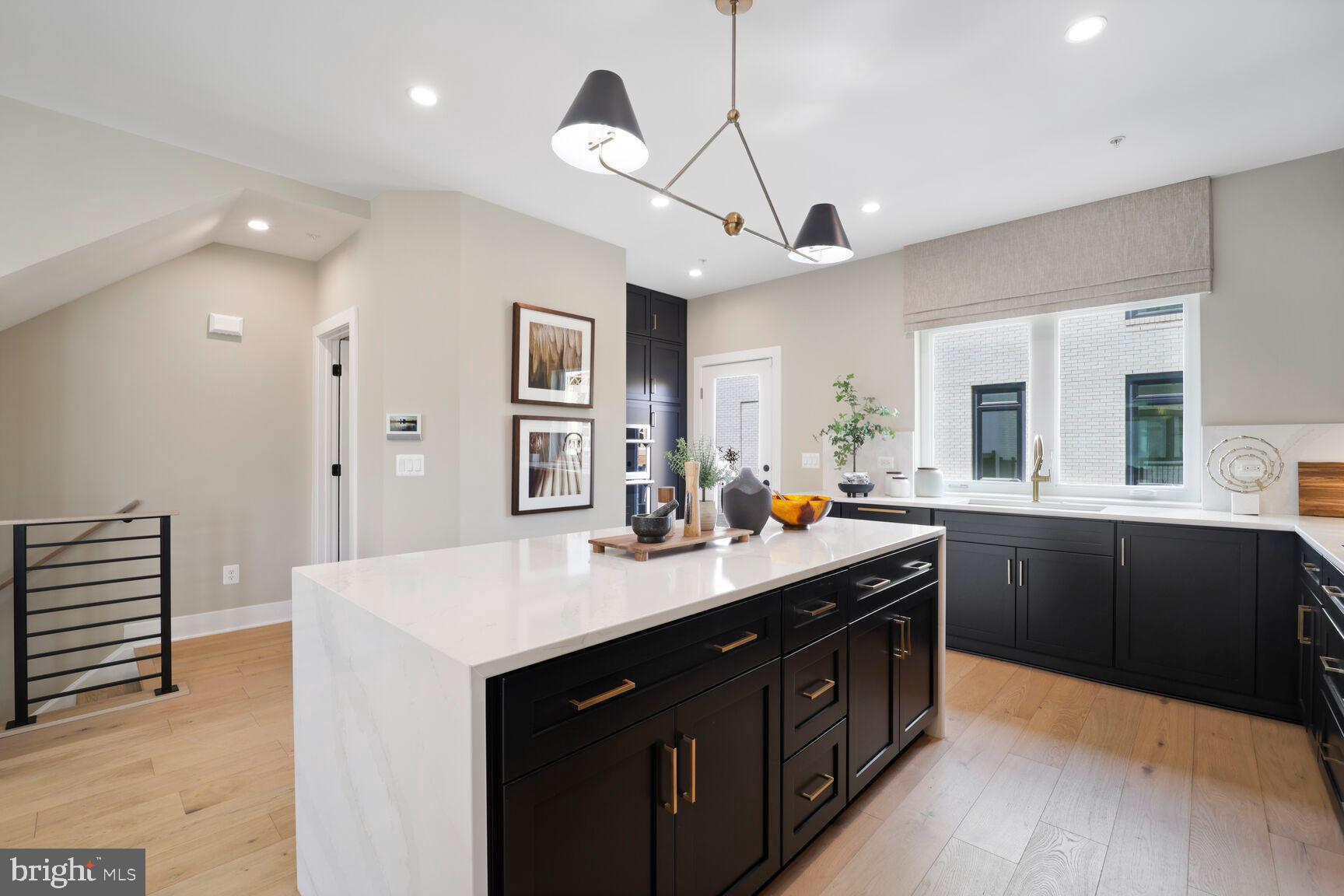 61 Lower Service Road Northwest, Unit HOMESITE 908 Washington, DC 20422 - Photo 3 of 22 a kitchen with counter top space sink and center island