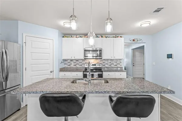 a stove top oven sitting inside of a kitchen