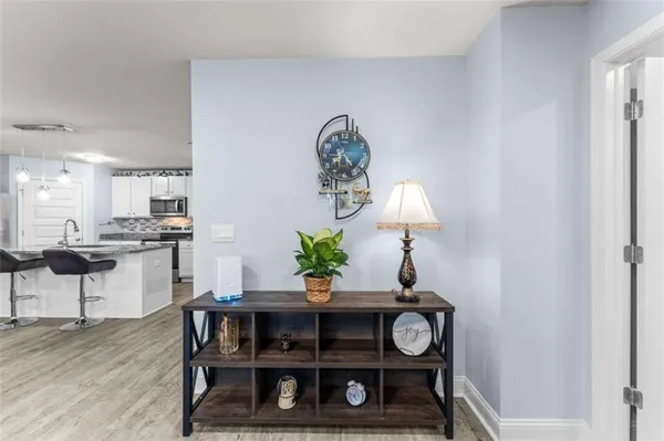 a bedroom with a bed and dresser with mirror