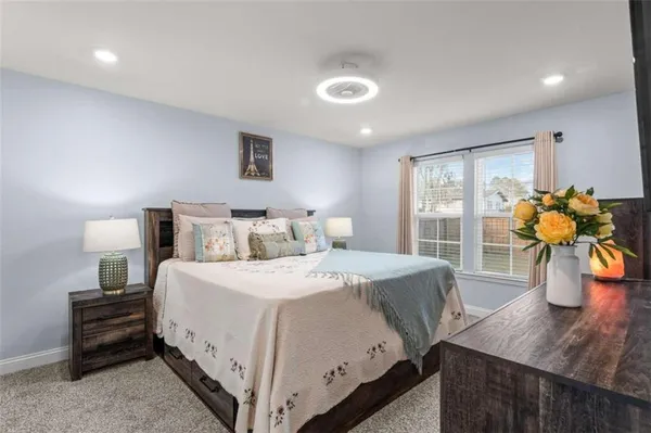 a bathroom with a granite countertop sink two mirror a bathtub and shower