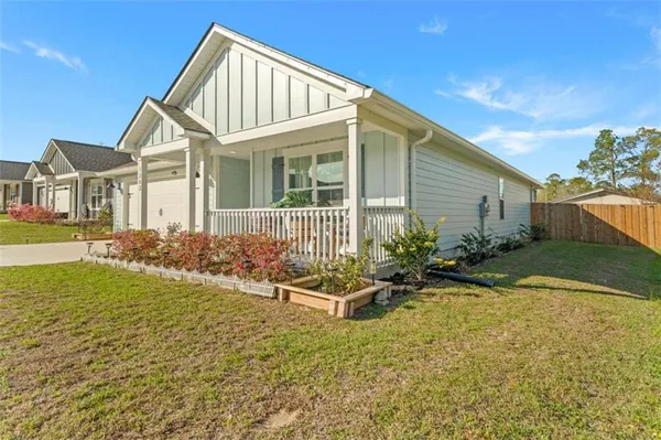 a view of backyard of house with outdoor seating and yard