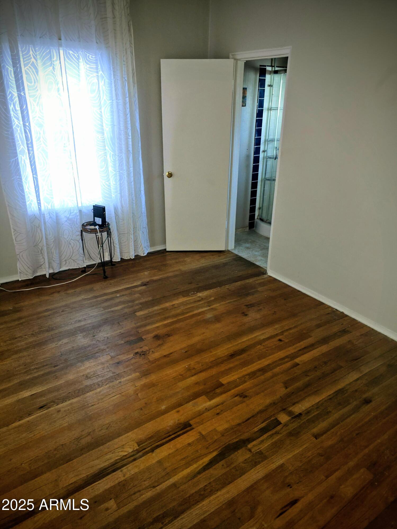 110 Arizona Street Bisbee, AZ 85603 - Photo 13 of 25 a view of an empty room with window and stairs