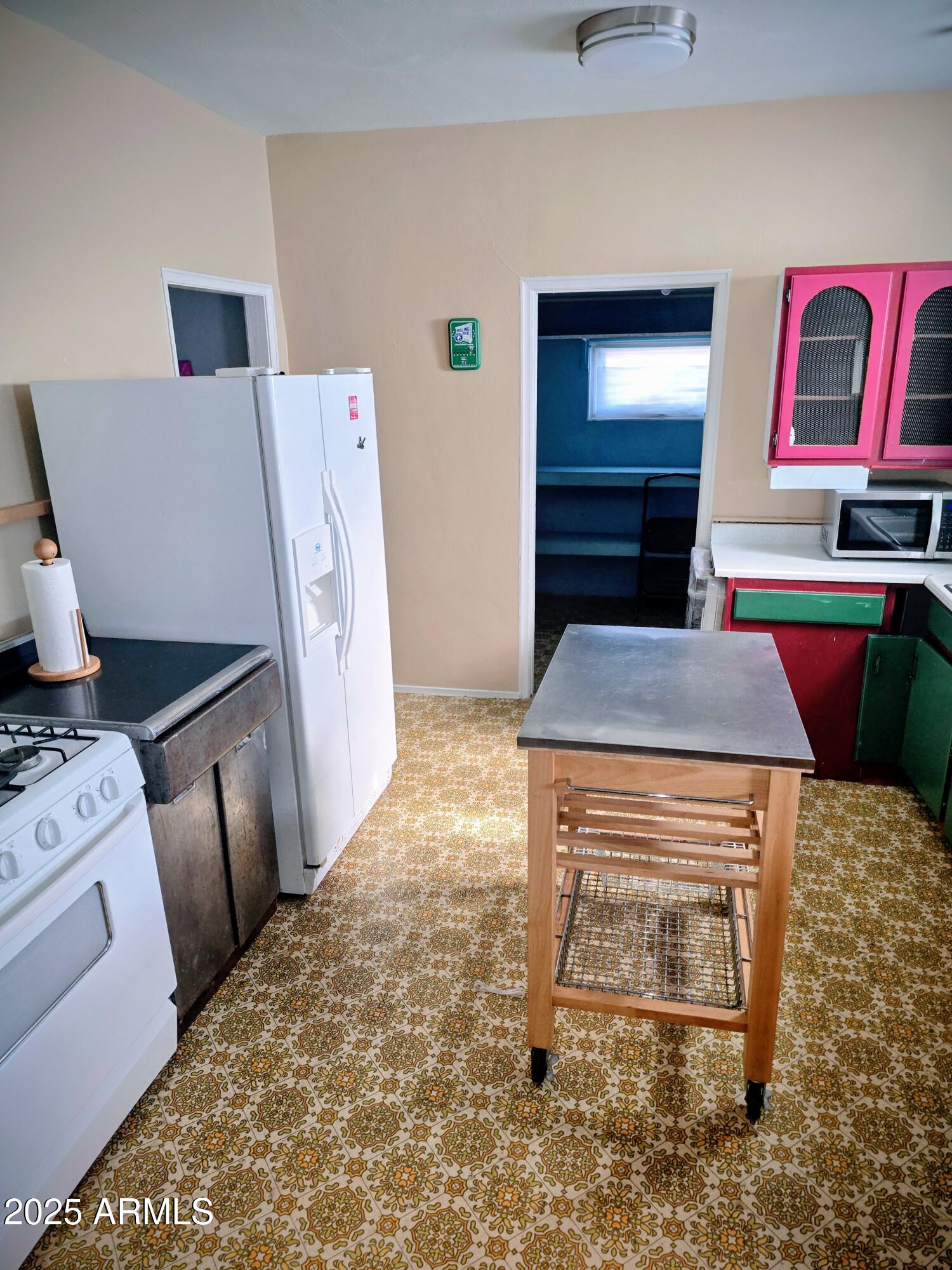 110 Arizona Street Bisbee, AZ 85603 - Photo 18 of 25 a living room with a couch and a stove top oven