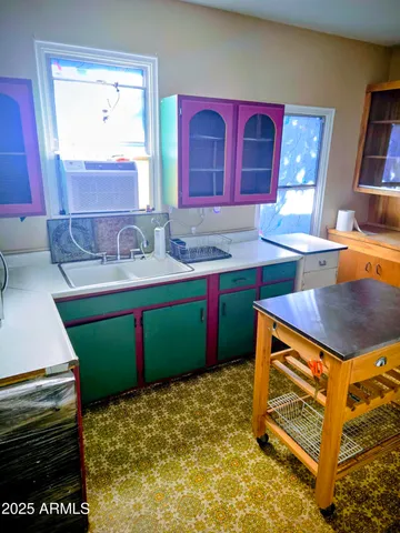 a kitchen with a sink stove and cabinets