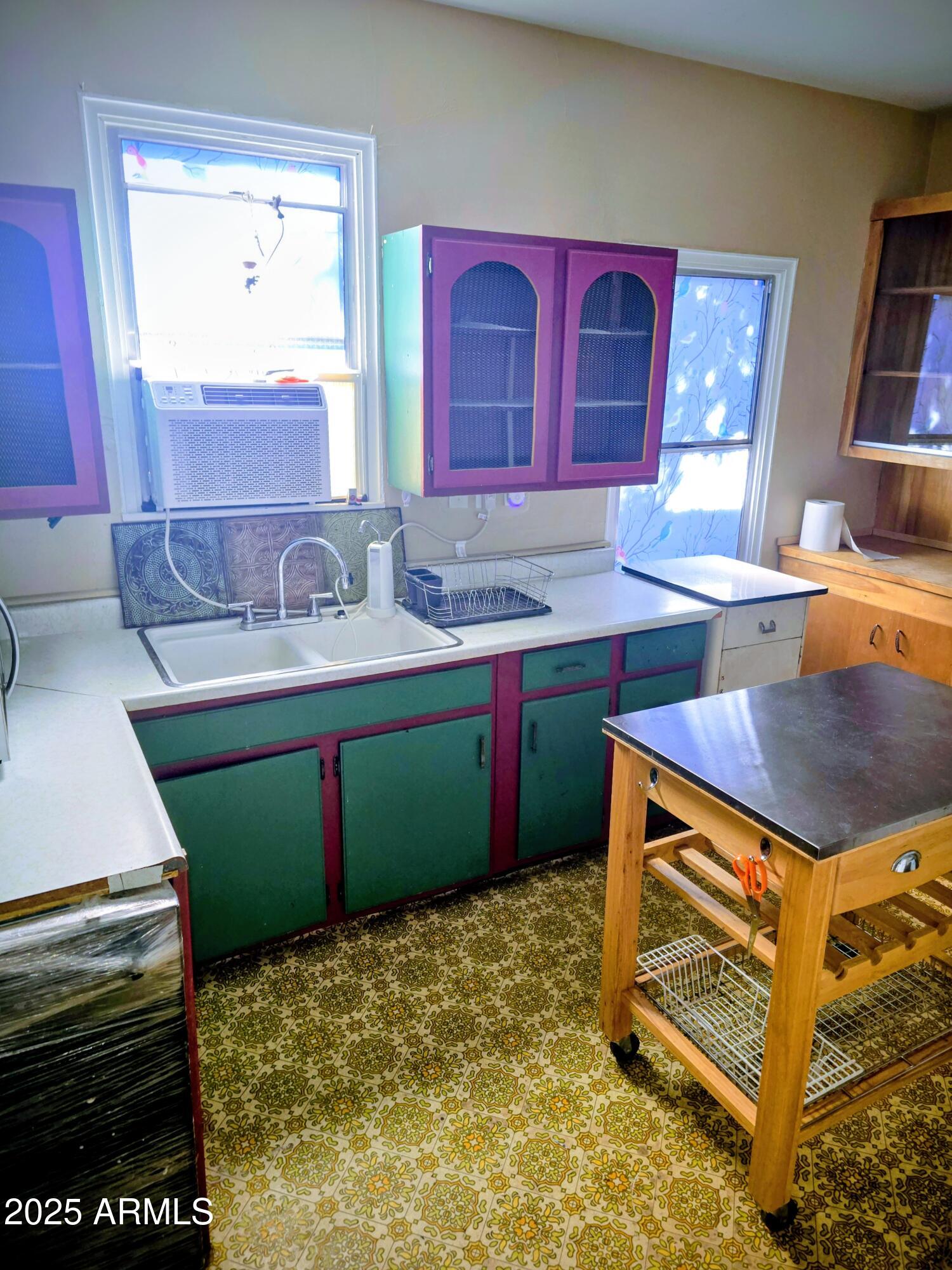 110 Arizona Street Bisbee, AZ 85603 - Photo 19 of 25 a kitchen with a sink stove and cabinets
