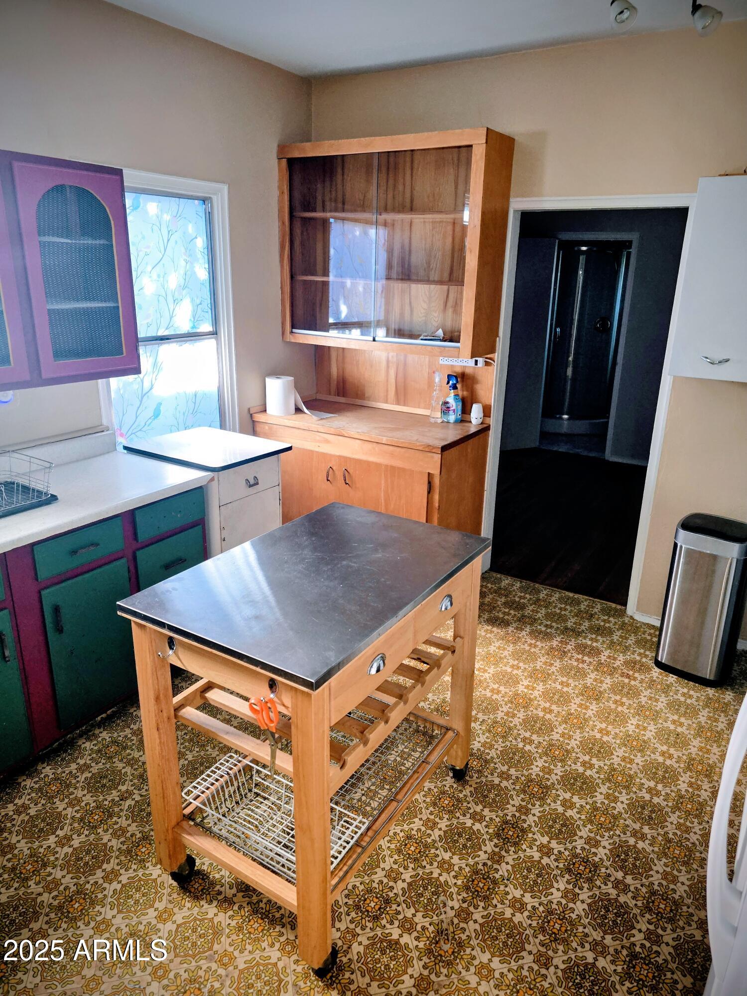 110 Arizona Street Bisbee, AZ 85603 - Photo 20 of 25 a kitchen with a sink a counter top space and a window