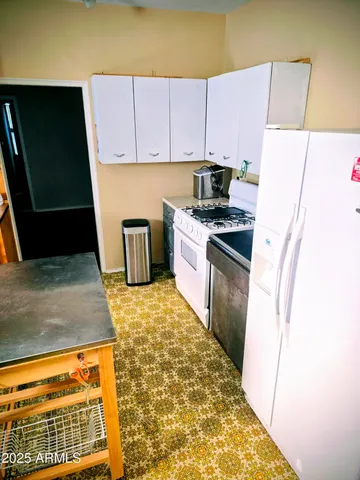 a kitchen with a refrigerator sink and stove