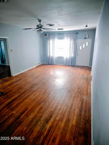 wooden floor in an empty room with a window