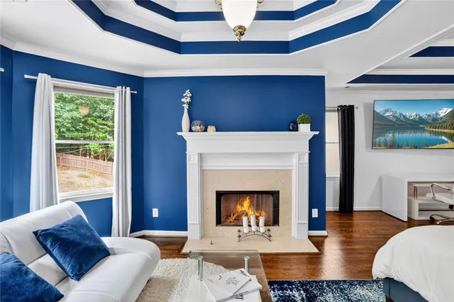 a view of an empty room with a window and fireplace