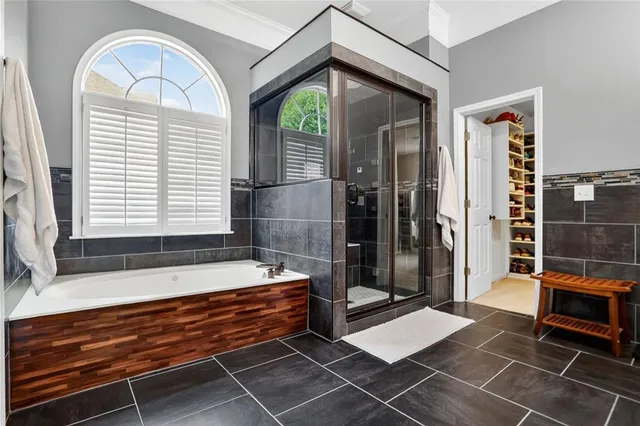 a front view of a house with a yard and potted plants