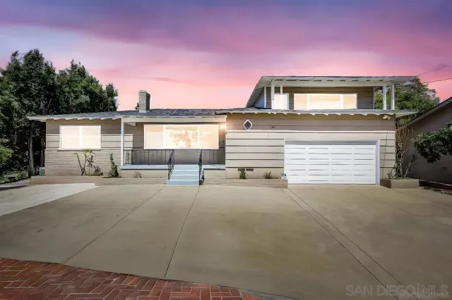 a view of a house with a yard and garage