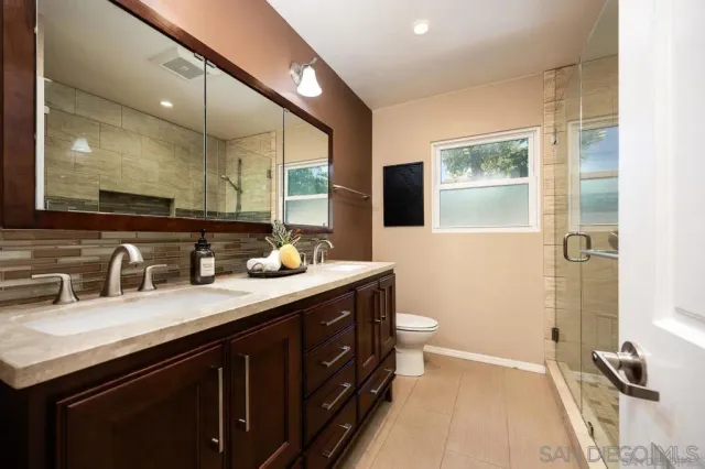 a bathroom with a granite countertop sink a mirror and a