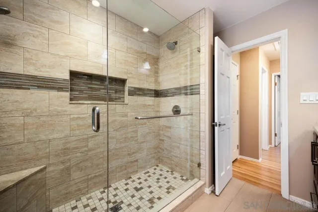 a bathroom with a shower and a sink