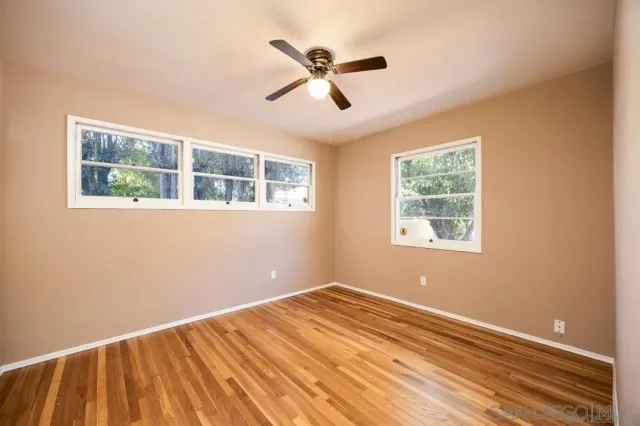 a view of room with window and ceiling fan