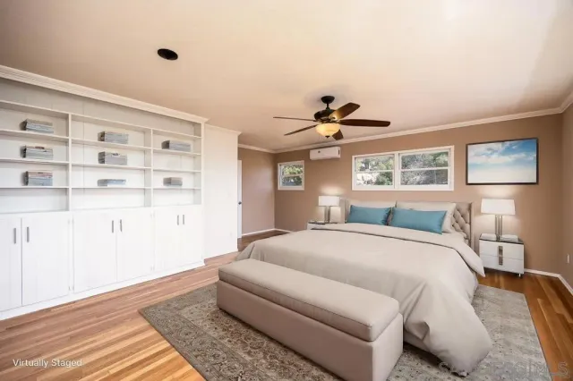 a spacious bedroom with a bed and a cabinets