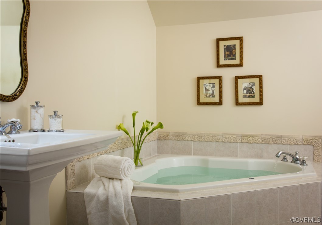 4750 Warner Hall Road Gloucester, VA 23061 - Photo 25 of 49 a bath tub sitting next to a white sink