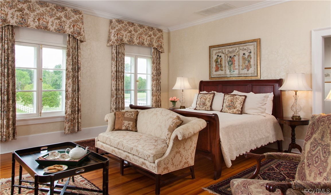 4750 Warner Hall Road Gloucester, VA 23061 - Photo 30 of 49 a bedroom with a bed and wooden floor