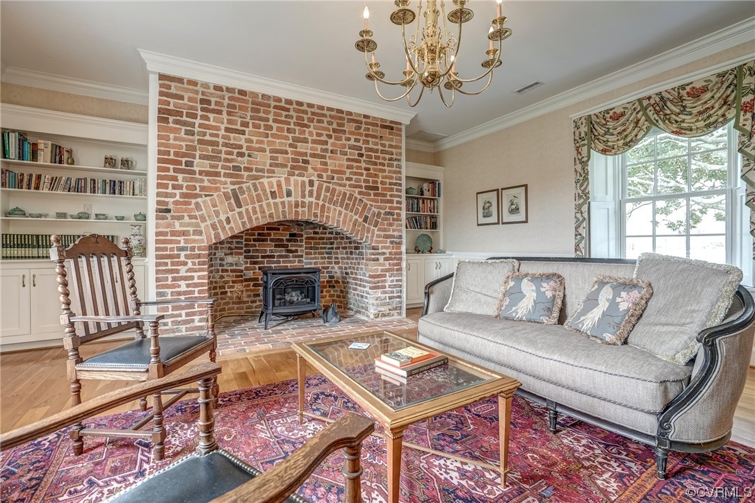 4750 Warner Hall Road Gloucester, VA 23061 - Photo 38 of 49 a living room with furniture a fireplace and a chandelier