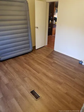 a view of a balcony with wooden floor