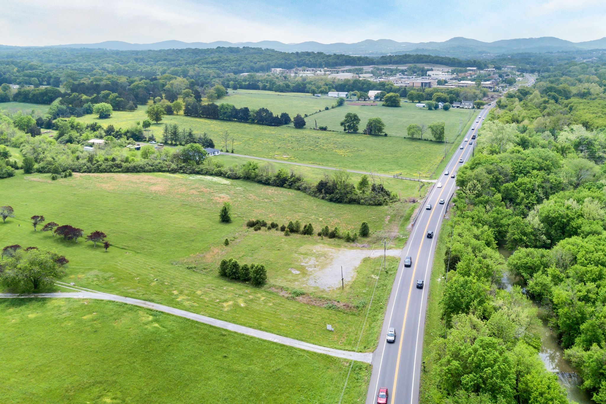 0 Nolensville Road Brentwood, TN 37027 - Photo 12 of 27 an aerial view of green landscape with trees houses and mountain view