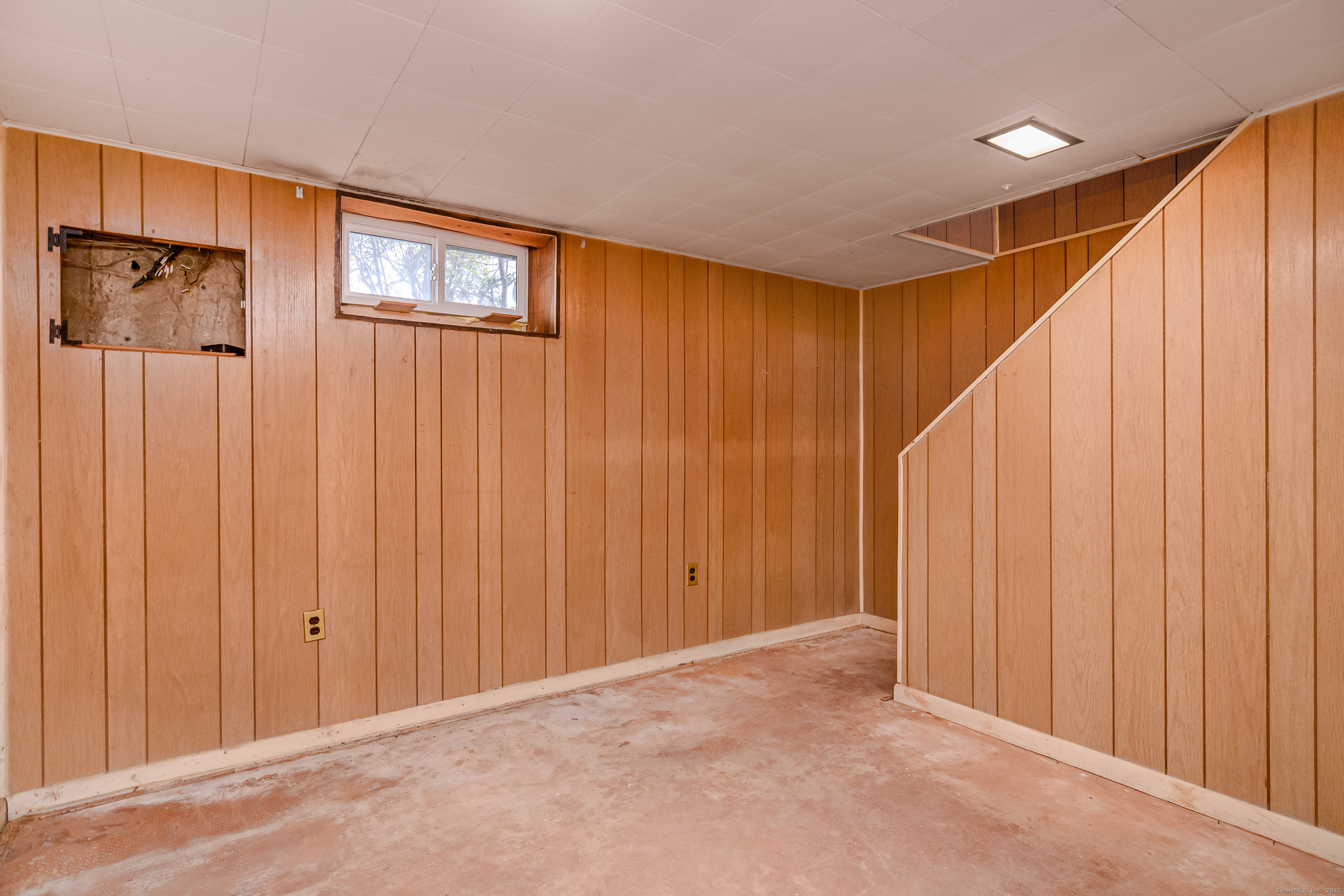 114 Sylvan Knoll Road Stamford, CT 06902 - Photo 14 of 23 a view of a hallway with wooden walls and stairs