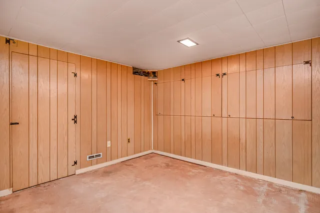 an empty room with a wooden door