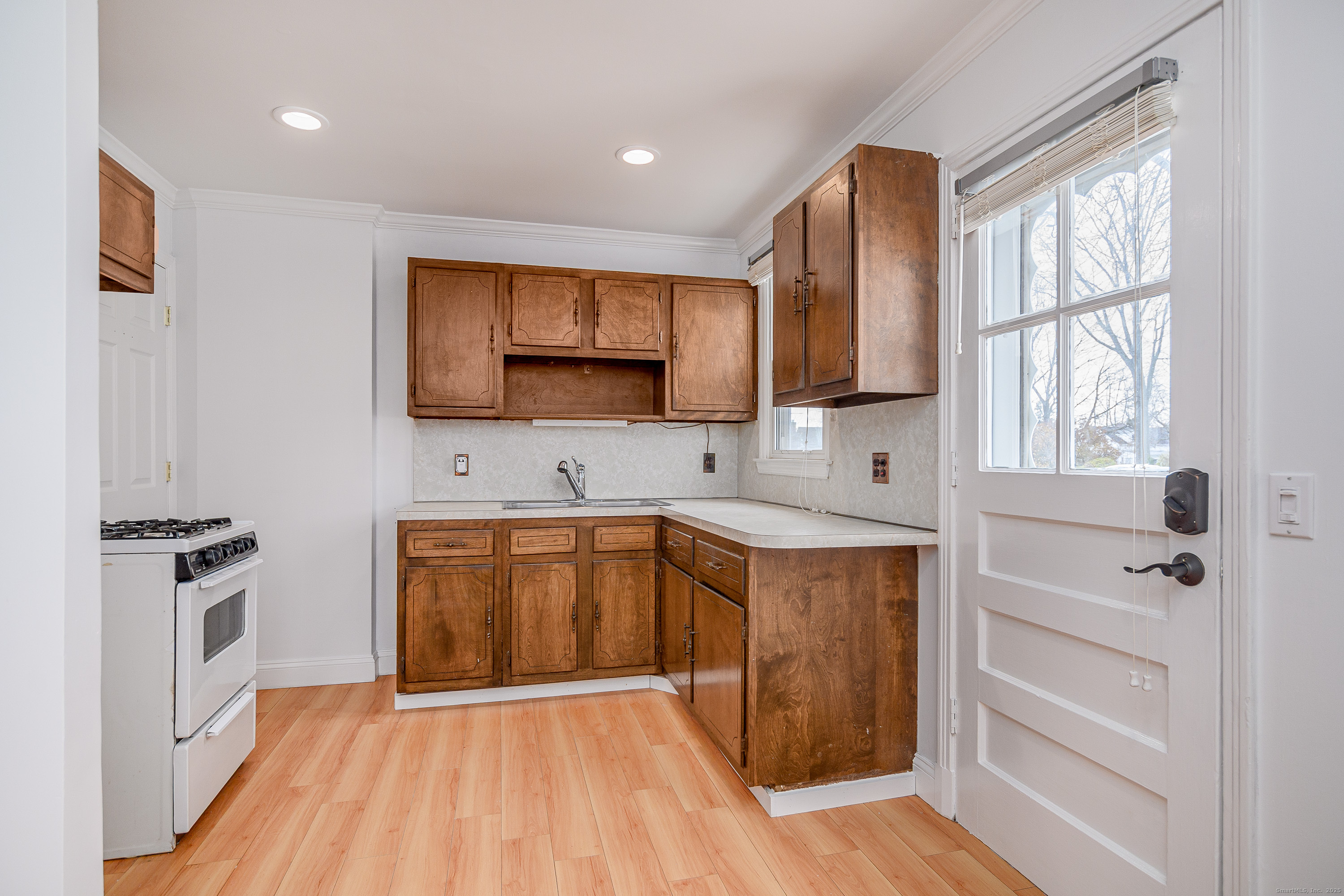 114 Sylvan Knoll Road Stamford, CT 06902 - Photo 7 of 23 a kitchen with stainless steel appliances granite countertop a stove a sink and a microwave